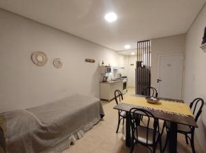 a room with a bed and a table with chairs at Departamentos Equipados Realico in Realicó