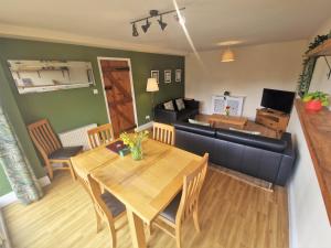 a living room with a table and a couch at The Granary in Leighton Buzzard
