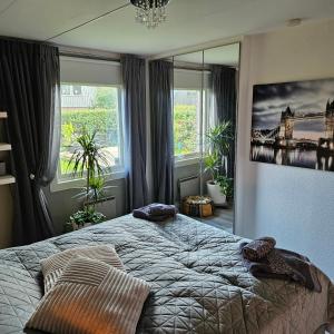 a bedroom with a large bed and a large window at Room in a luxury villa for Eurovision week-end in Åkarp
