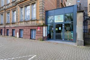 a store front of a building on a street at Adonis Hotel Strasbourg in Strasbourg