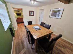 a dining room with a wooden table and chairs at The Mill in Leighton Buzzard +20 photos