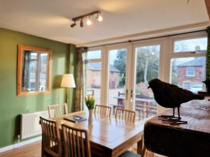 a bird sitting on top of a wooden table at The Dairy in Leighton Buzzard