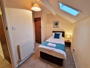 a bedroom with a bed and a skylight at The Dairy in Leighton Buzzard
