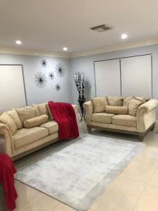 a living room with two couches and a rug at Perfect get away from big city life in Freeport