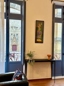 a living room with a couch and a window at La Suite de la Cathédrale in Narbonne