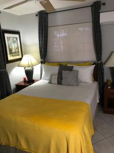 a bedroom with a large bed with a yellow blanket at Perfect get away from big city life in Freeport