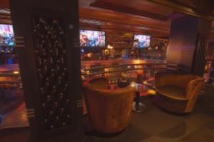 a bar with chairs and a counter in a room at Hotel Edison Times Square in New York