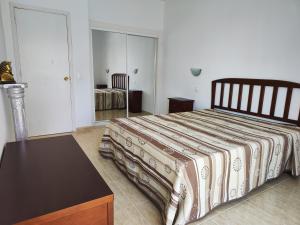 a bedroom with a bed and a dresser in it at Olga Paraiso del Sur in Playa Paraiso