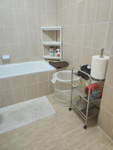 een badkamer met een bad, een wastafel en een plank bij Olga Paraiso del Sur in Playa Paraiso