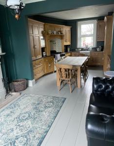 a kitchen with a wooden table and a dining room at Sherwood House in Matlock