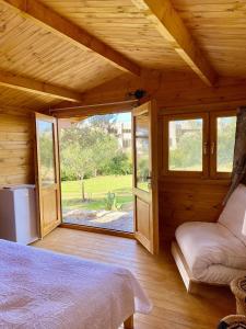 カンディアにあるEudaimonia Wooden Suites Nafplio Kandiaのベッドルーム1室(ベッド1台、大きな窓付)