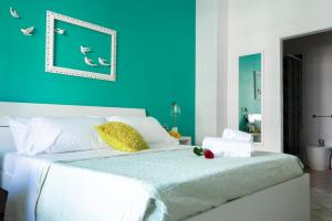 a bedroom with a bed with a blue wall at Reginella Guest House in Salerno