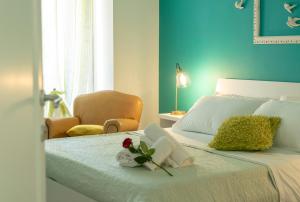 Un dormitorio con una cama con una flor y un libro en Reginella Guest House, en Salerno
