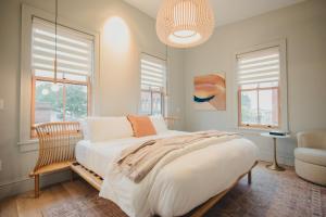 a bedroom with a large bed and windows at St. James Social in Bayfield