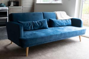 a blue couch with blue pillows in a living room at Bridge & Shard Hideaway in London