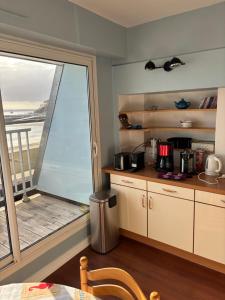 a kitchen with a window with a view of the ocean at L'Imprenable vue mer in Crozon