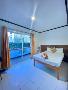 a bedroom with a bed and a large window at VILLA LOURDES RESORT in Boracay