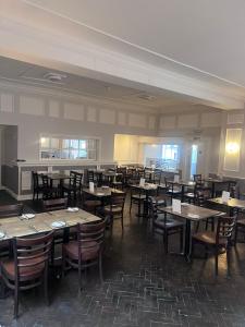 a dining room filled with tables and chairs at Aston Court Hotel in Derby