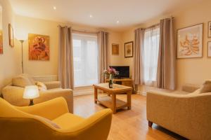 a living room with two couches and a tv at Charming city centre 2 bed apartment - Sleeps 4. With Parking. in Chester