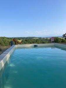 a swimming pool with a view of the ocean at La Toumet in Malabat