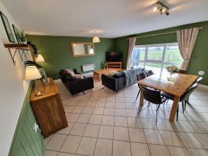 a living room with a couch and a table at The Homestead in Leighton Buzzard