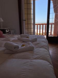 two beds in a room with towels on them at Hotel con Hermosa Vista al Mar MDQ in Mar del Plata