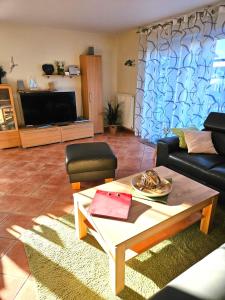 a living room with a couch and a coffee table at Ferienhaus Sabine Norddeich in Norddeich