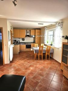 a kitchen with a table and chairs in a room at Ferienhaus Sabine Norddeich in Norddeich