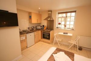 a small kitchen with a table and a window at The Egg Room in Ivinghoe