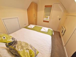 Habitación pequeña con 2 camas y toallas en Lime Kiln, en Leighton Buzzard