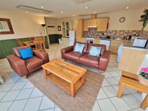 a living room with two chairs and a coffee table at Town End in Leighton Buzzard