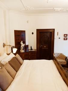 a bedroom with a bed and a couch and a table at Boutique hotel & Wellness Spitzerova vila Eliška in Janovice +19 photos