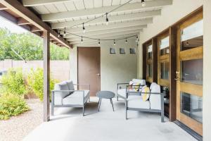 a patio with white furniture and a table and chairs at Heated Pool Outdoor Kitchen Patio Modern Design in Scottsdale