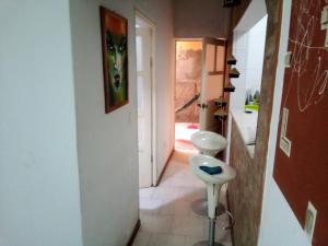 a hallway with a white stool in a room at Borges Place in Praia