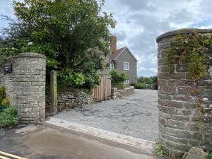 an entrance to a house with a stone wall at Humphreston House in Temple Cloud