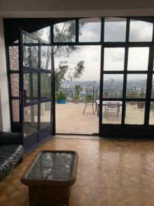 a living room with a large glass door with a patio at SSHC Apartments in Addis Ababa
