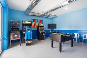 a room with two arcade games and a table and a game at Panoramic Lake Views, Free Silver Dollar City Tickets, Stunning Decor in Kimberling City