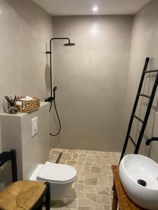 a bathroom with a white toilet and a sink at Cabanon d’Amata in Saint-Raphaël