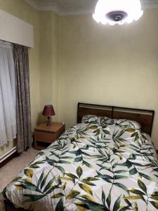 a bedroom with a bed and a lamp on a table at The best known village of Belgium in Puurs