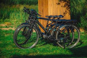 a couple of bikes parked next to a wooden pole at Million star hotel Latgale in Nastrova