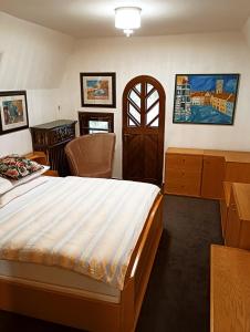 a bedroom with a large bed and a desk and a desk at Boutique hotel & Wellness Spitzerova vila Eliška in Janovice