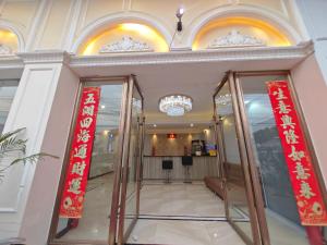 a lobby with two red signs in a building at 九号公馆 in Ban Dông-Naxôk