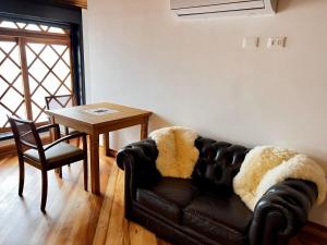 a living room with a couch and a table at Hotel Savoy Excellence in Campos do Jordão