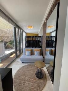 a living room with a couch and a table at Deluxe Sunrise Sky Terrasse 2 Bedroom Design Apartment & Fantastic Lake View in Maderno +48 photos