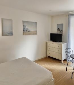 una camera con un letto e un comò con una televisione di Saldanha Guest House a Lisbona