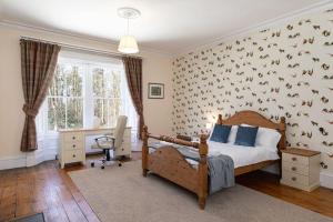 a bedroom with a bed with birds on the wall at Magnificent Period Country House in Rothley