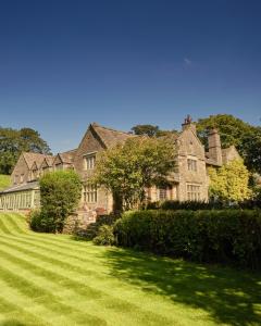 a large stone house with a large yard at Stone House Hotel in Hawes