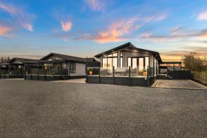 a rendering of a house with a lot of windows at Arranview Lochside Pods & Lodges all with private Hot-tubs in Fenwick