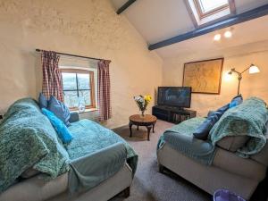 a living room with two couches and a tv at 2 Bed in Wasdale SZ053 in Nether Wasdale