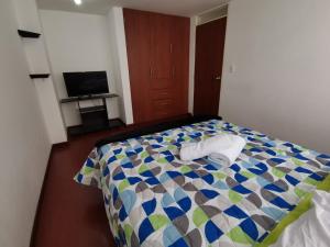 a bedroom with a bed with two towels on it at Aparta-estudio centro cerca plaza de bolívar Tunja in Tunja